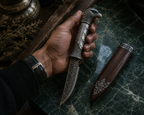 SENVIRRA Eagle Katar held in hand beside its wood sheath, shown for scale reference