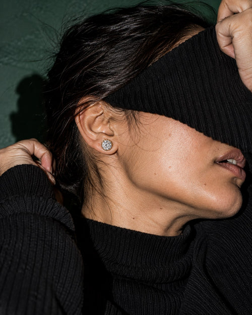 SENVIRRA solitaire stud earrings worn in an editorial portrait