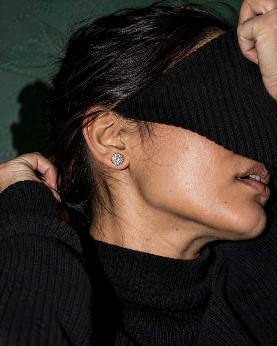SENVIRRA solitaire stud earrings worn in an editorial portrait