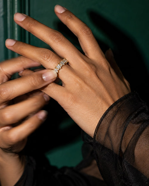 SENVIRRA gemstone ring worn in an elegant emerald-toned editorial photograph